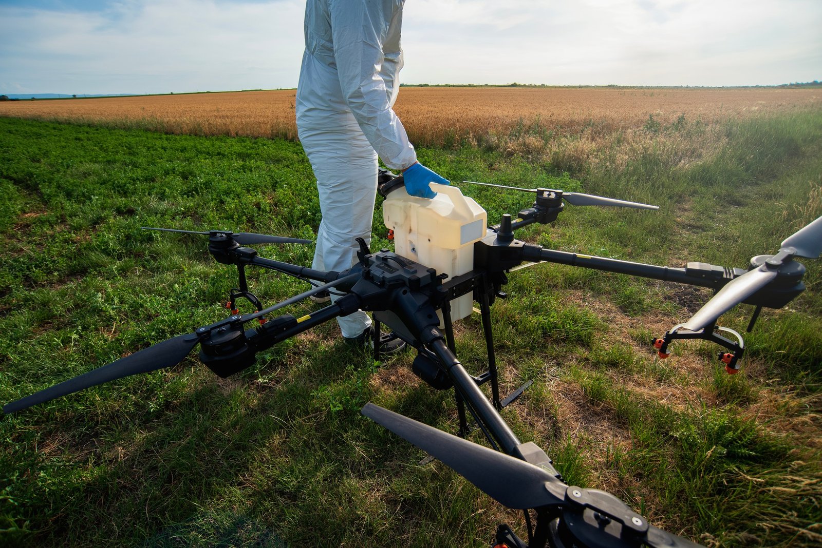 Drone operator, modern farmer with drone on agricultural fields